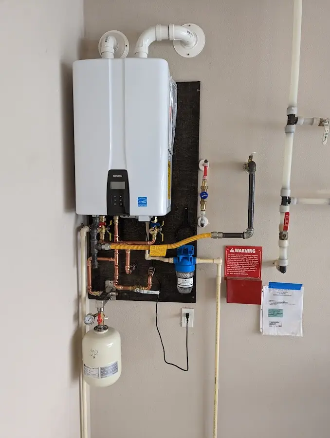 Professional plumber installing copper piping in a Ladonia home